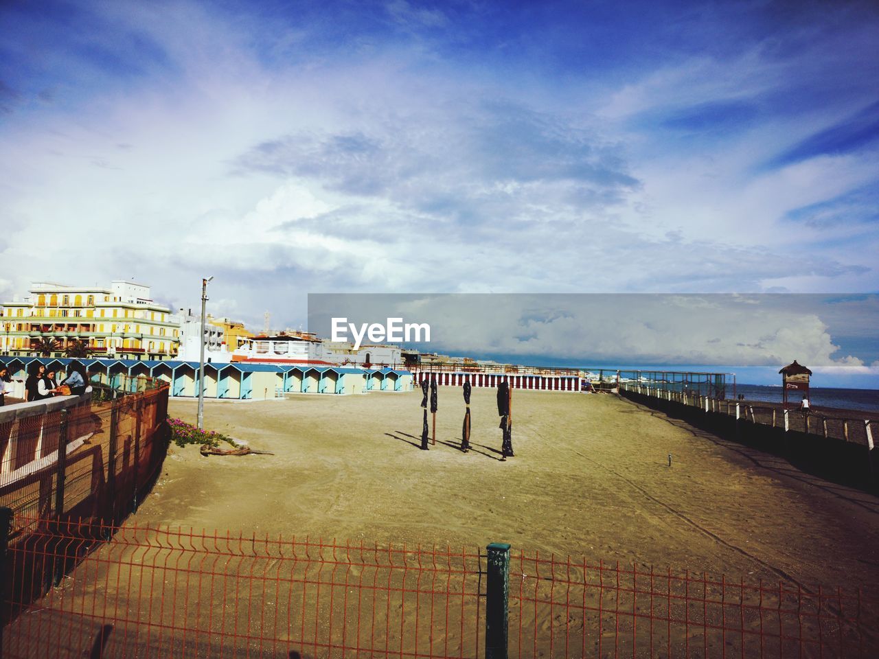 PIER ON FOOTPATH BY BUILDING AGAINST SKY