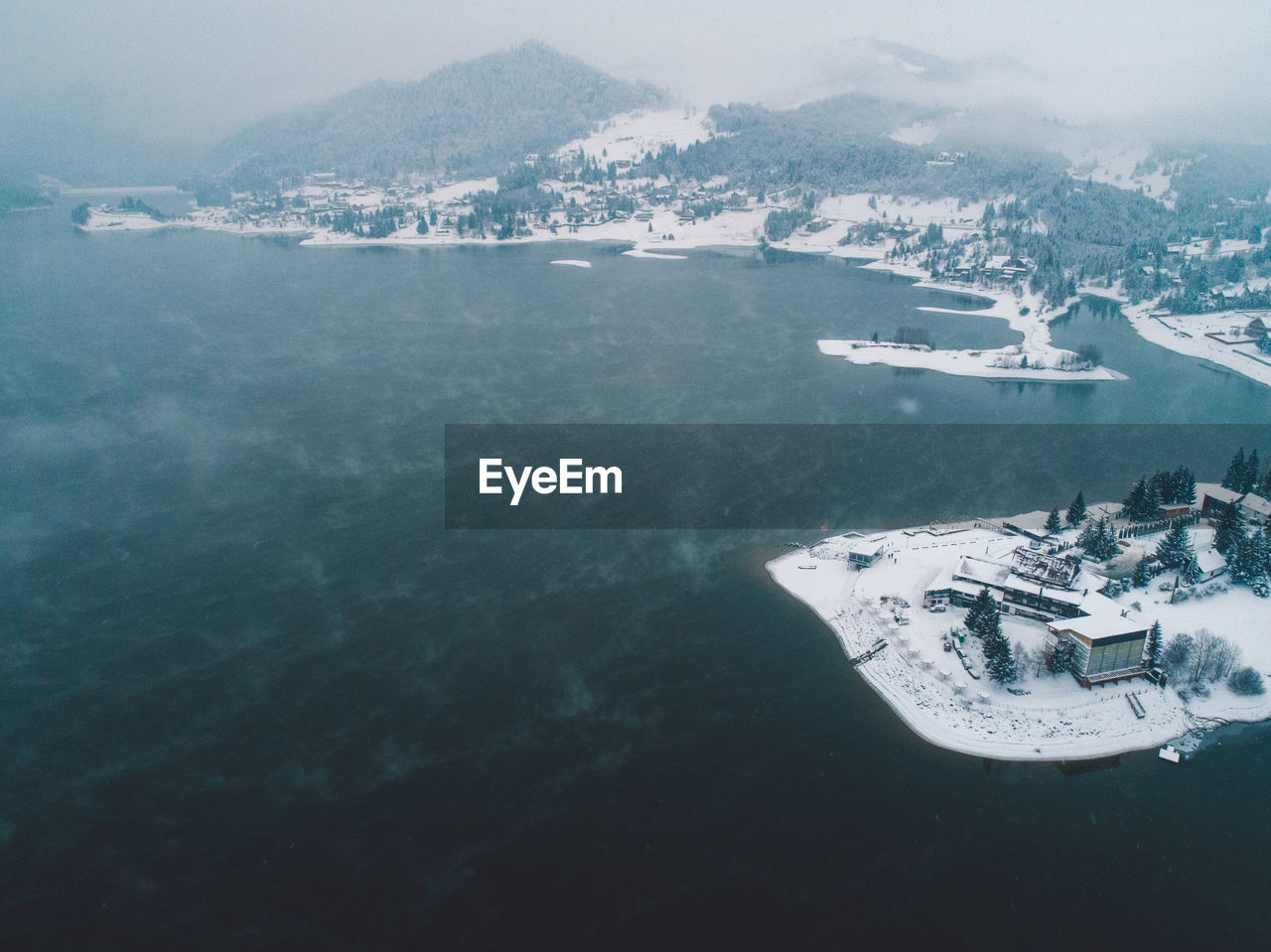 Aerial view of sea and snowcapped mountains