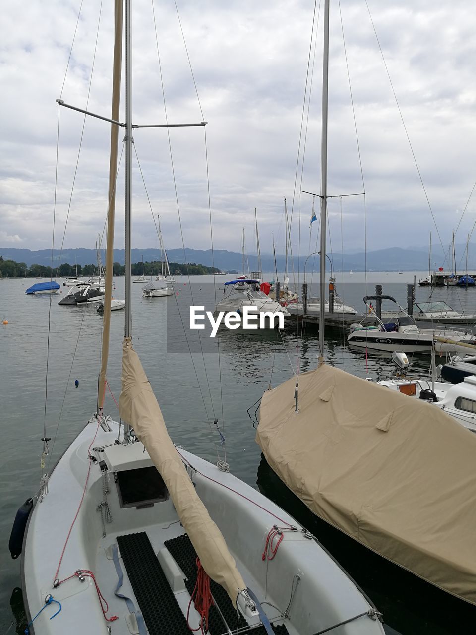 BOATS MOORED ON SEA AGAINST SKY