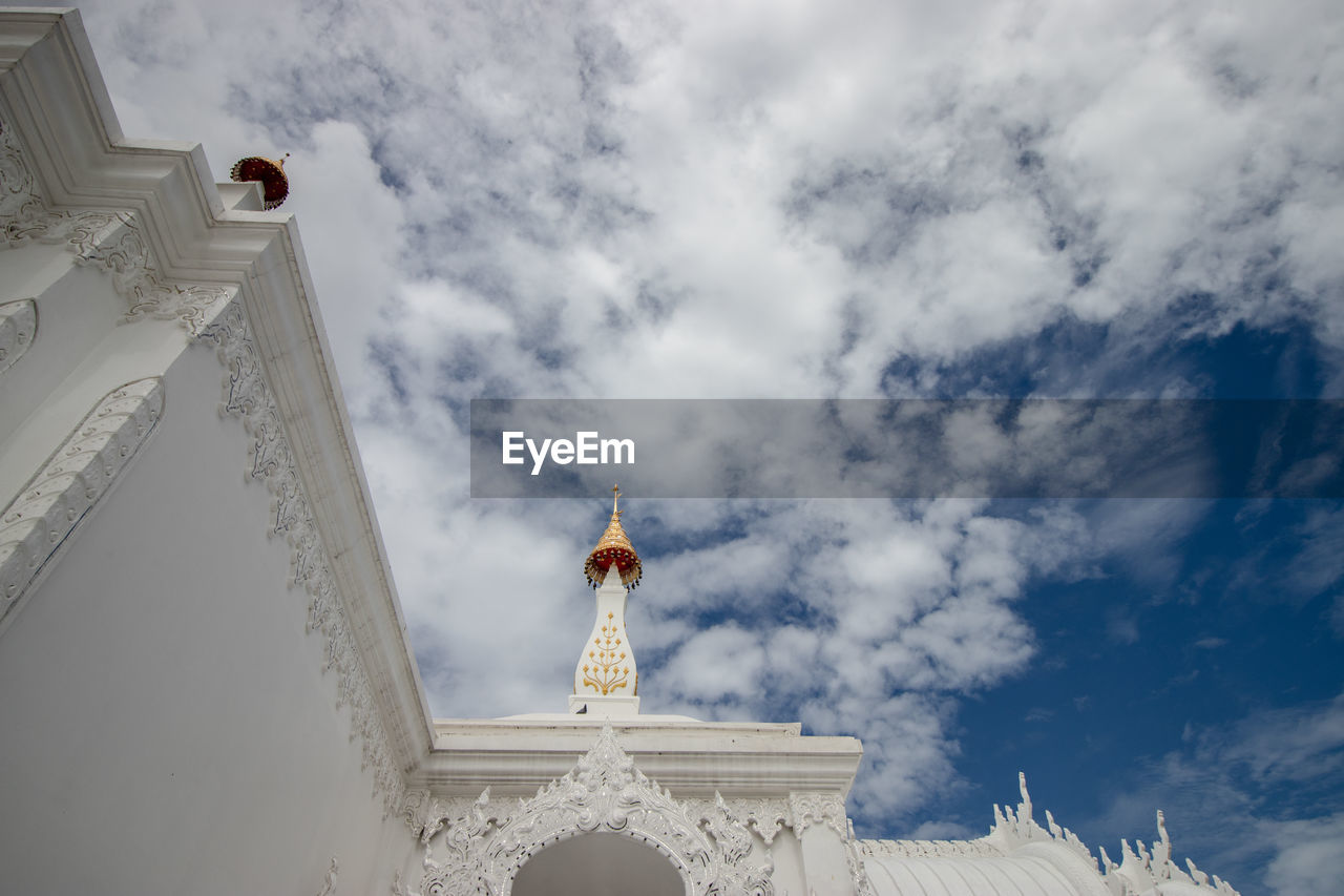 Low angle view of building against cloudy sky