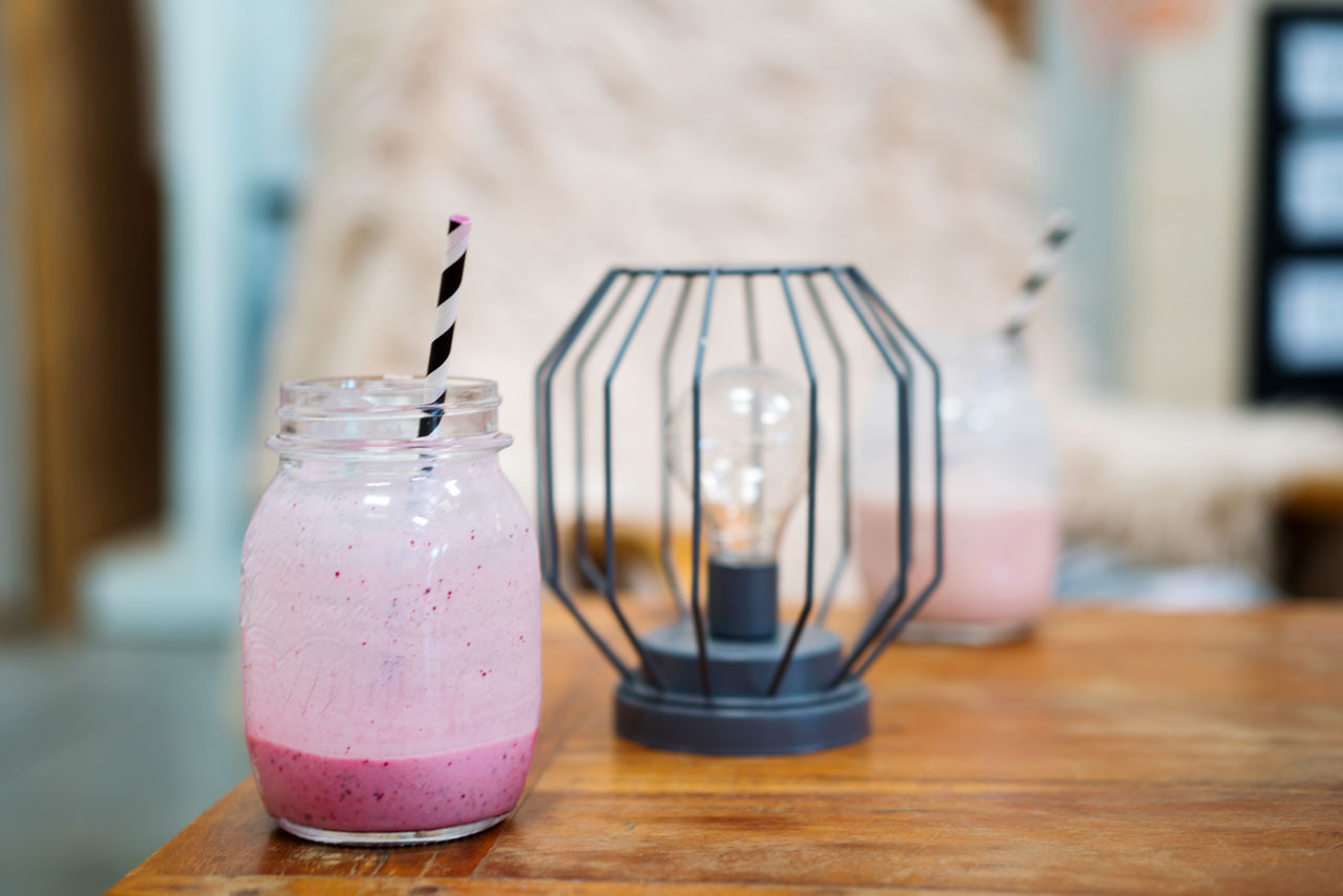 Pink smoothie on the wooden cozy table