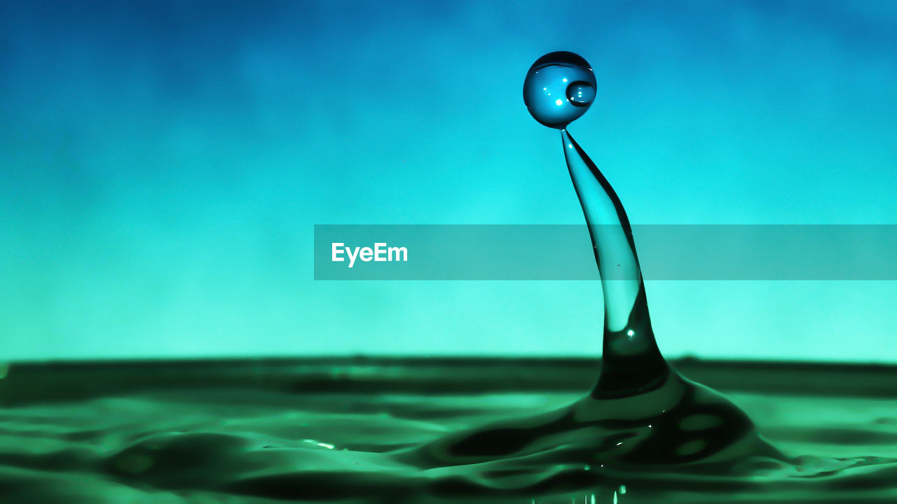 CLOSE-UP OF WATER DROP AT SWIMMING POOL