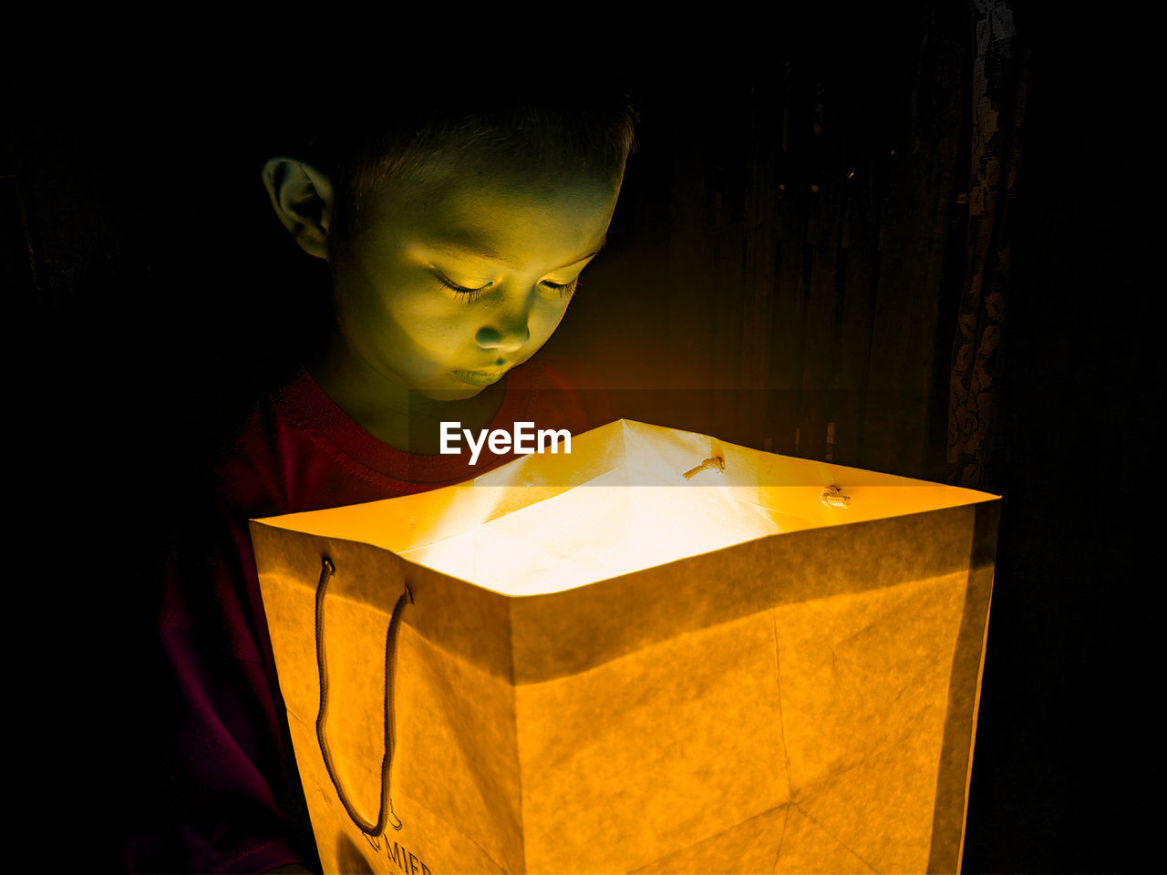 CLOSE-UP OF BOY HOLDING BOOK