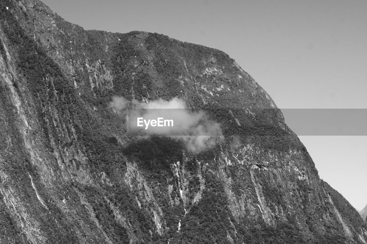 Top of a mountain with a small cloud.