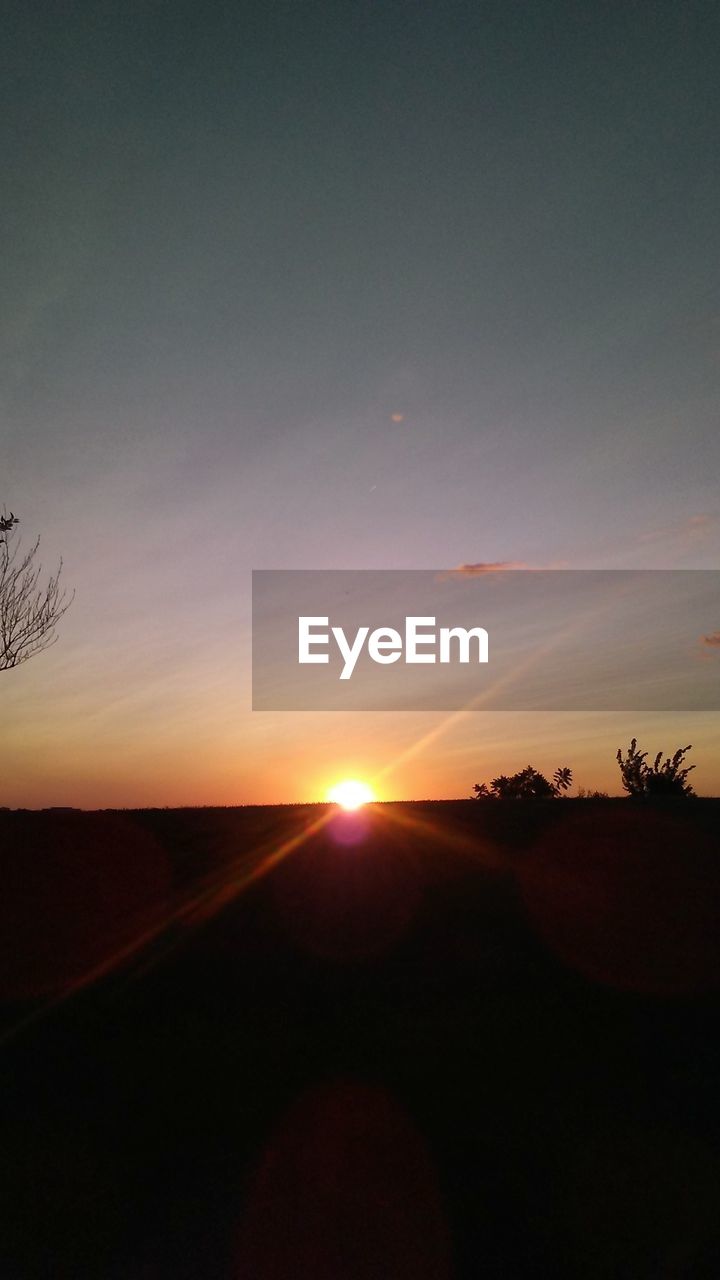 SUNSET OVER RURAL LANDSCAPE