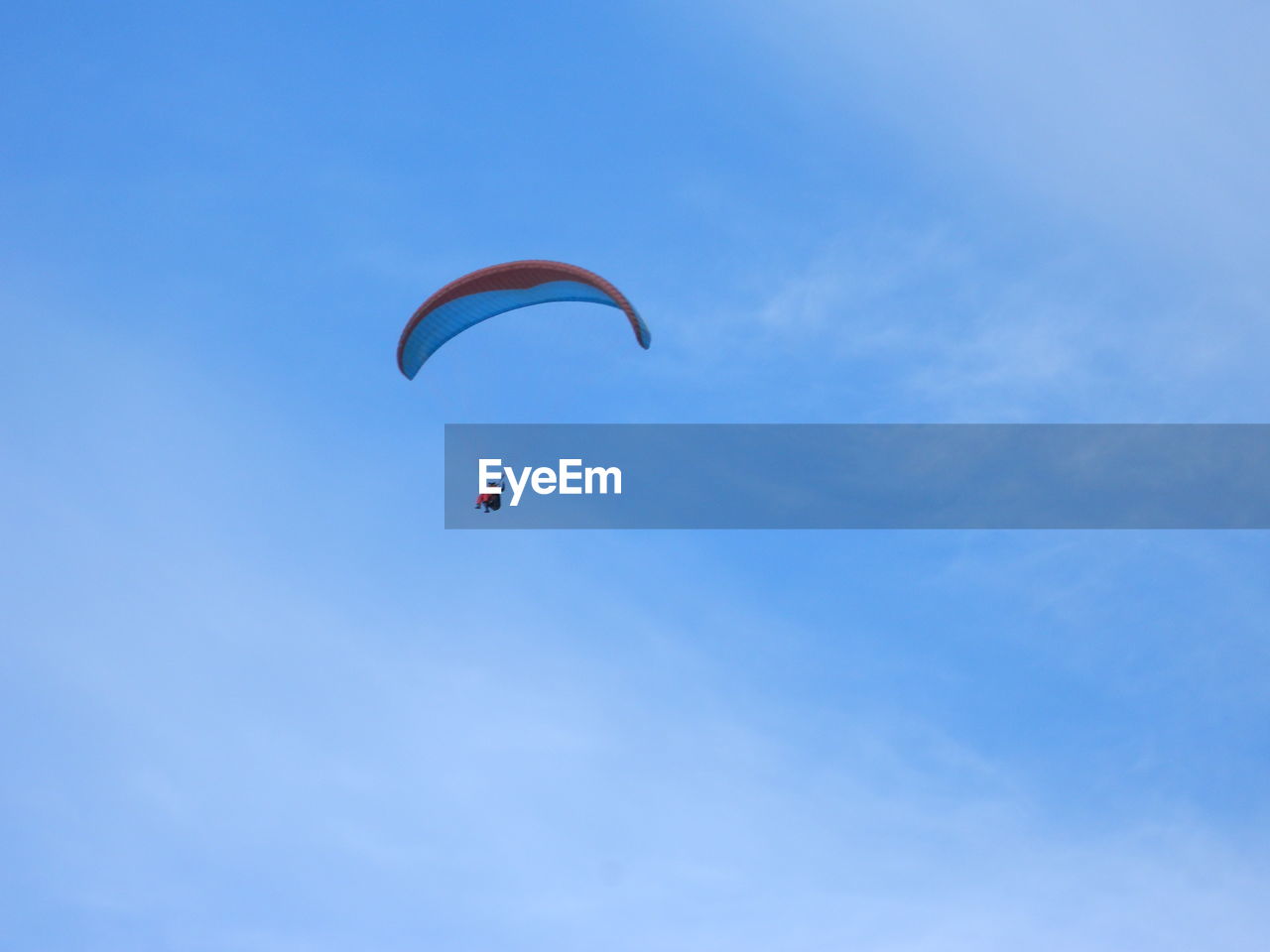 LOW ANGLE VIEW OF PERSON PARAGLIDING AGAINST CLEAR SKY