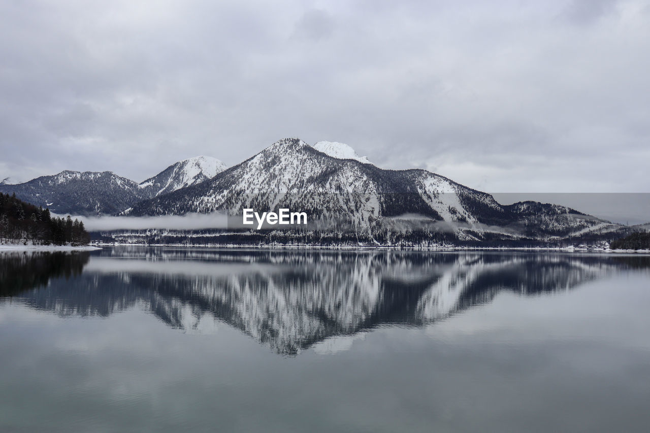 Scenic view of lake and snowcapped mountains against sky