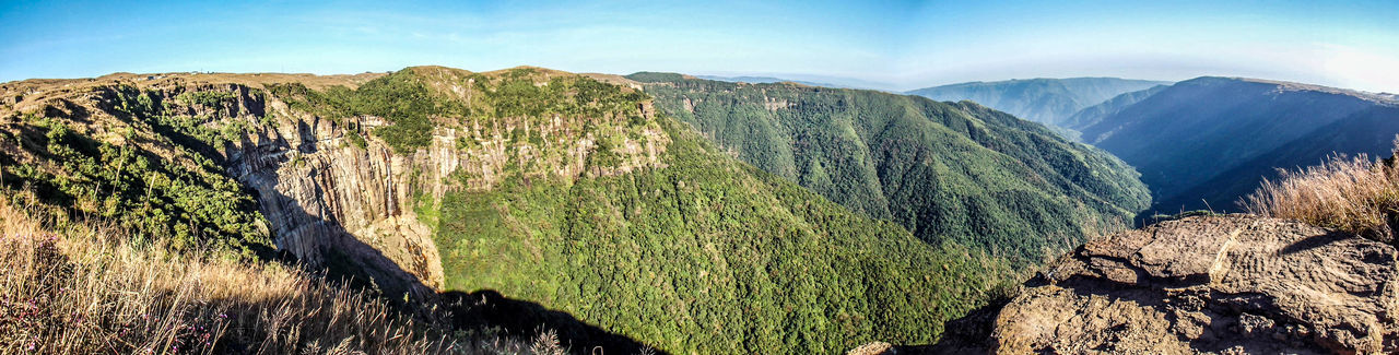 Close-up of green mountains against sky