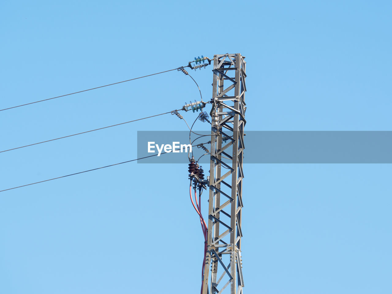 technology, electricity, sky, cable, blue, clear sky, overhead power line, low angle view, power supply, power generation, electricity pylon, transmission tower, no people, power line, nature, outdoor structure, tower, mast, day, line, communication, copy space, metal, outdoors, sunny, electrical supply, built structure, architecture, industry