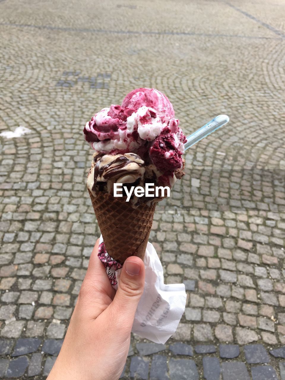 Cropped hand holding ice cream cone