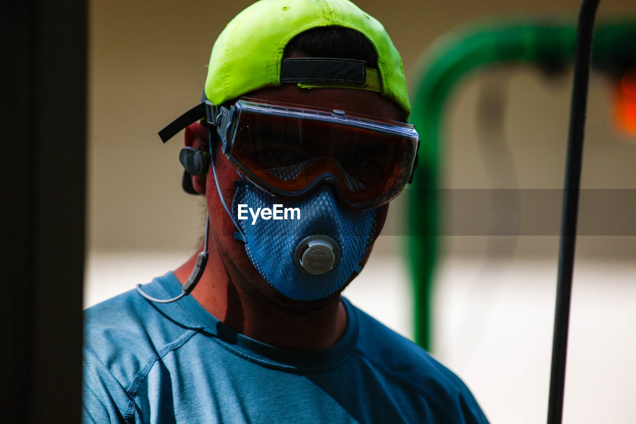 CLOSE-UP PORTRAIT OF A MAN WEARING MASK