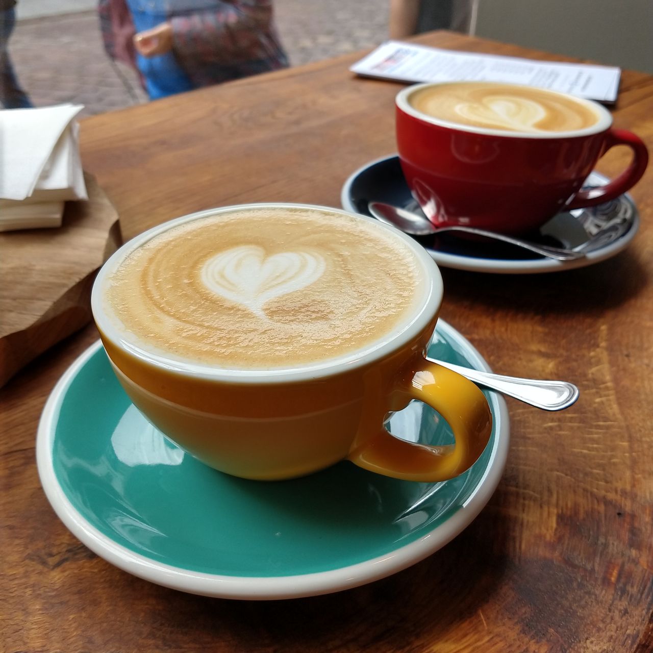 CUP OF COFFEE ON TABLE AT CAFE