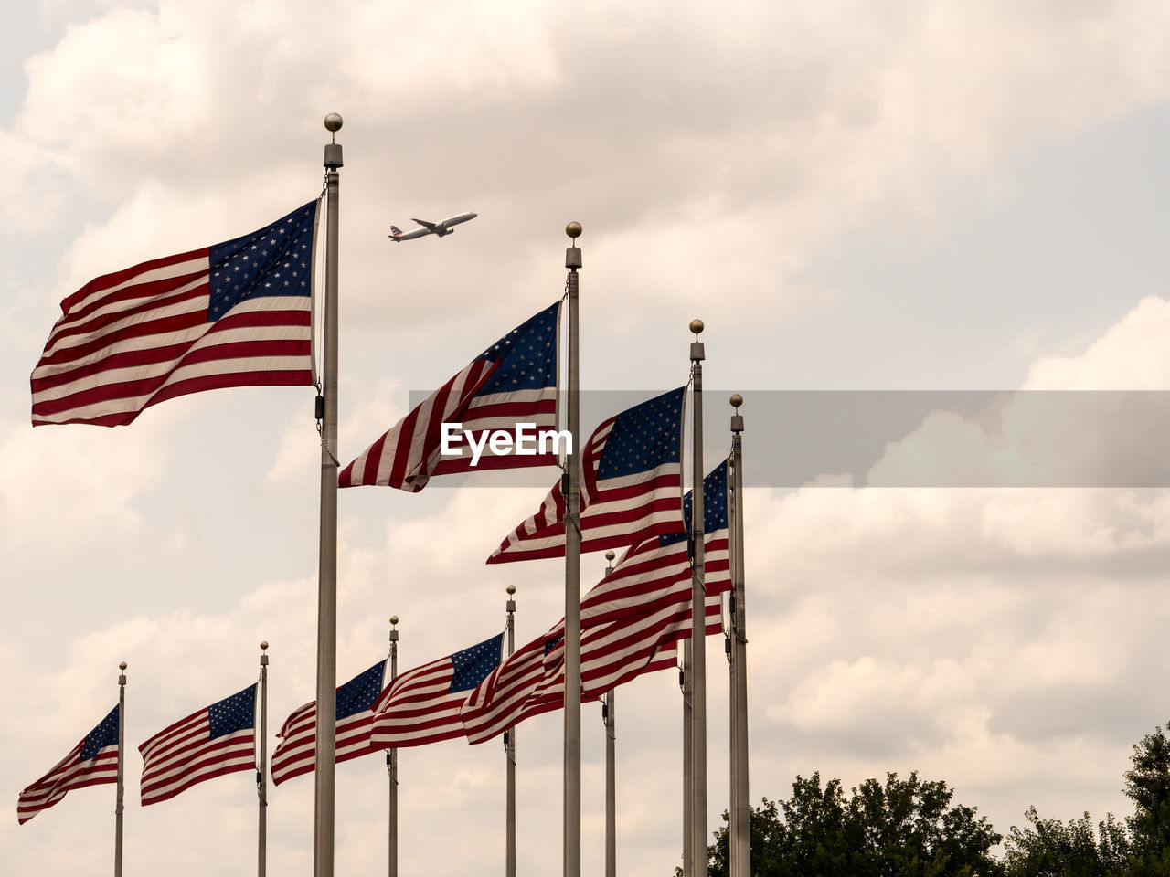 Low angle view of american flags against sky