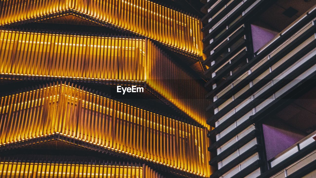 LOW ANGLE VIEW OF ILLUMINATED STAIRCASE AT BUILDING