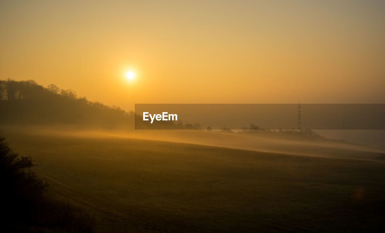 SCENIC VIEW OF SUNSET OVER LAND