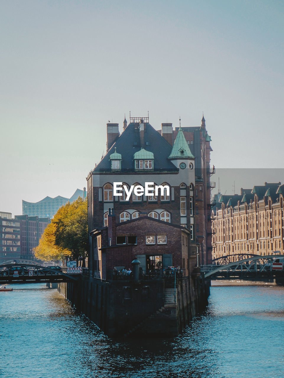 RIVER BY BUILDINGS AGAINST CLEAR SKY