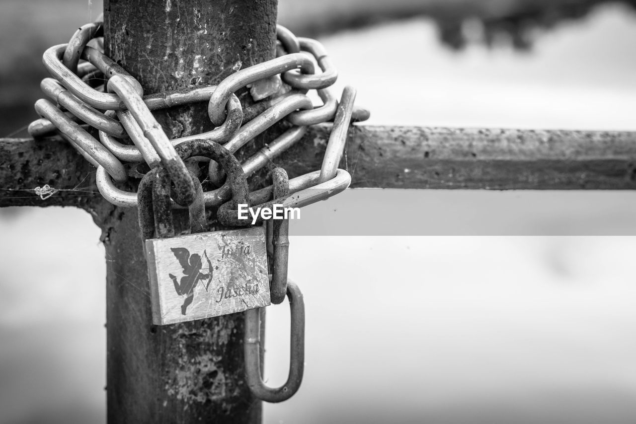 Chain with padlock on fence