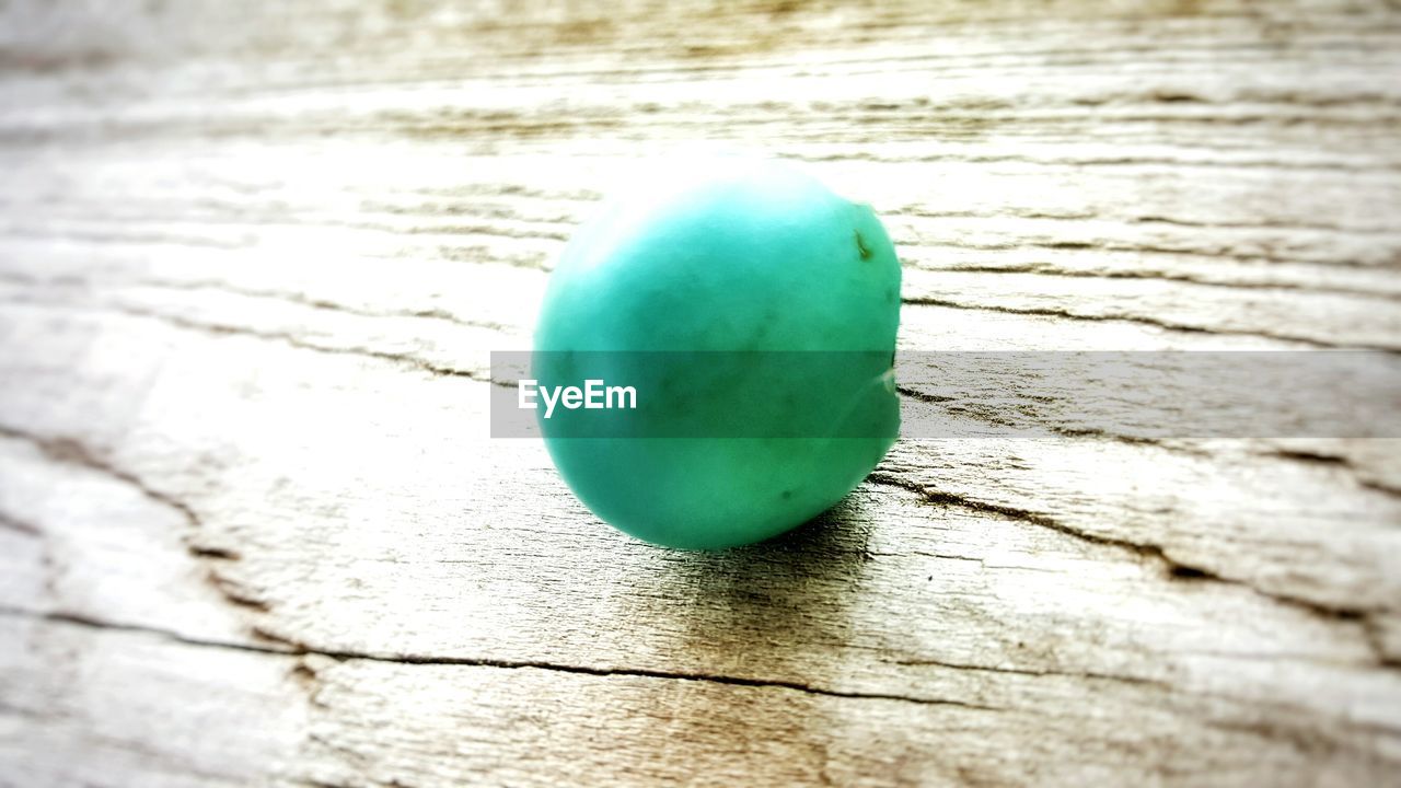 CLOSE-UP OF MULTI COLORED BALLS ON TILED FLOOR