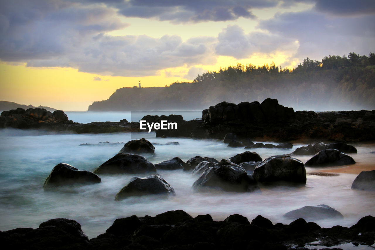 scenic view of beach against sky during sunset