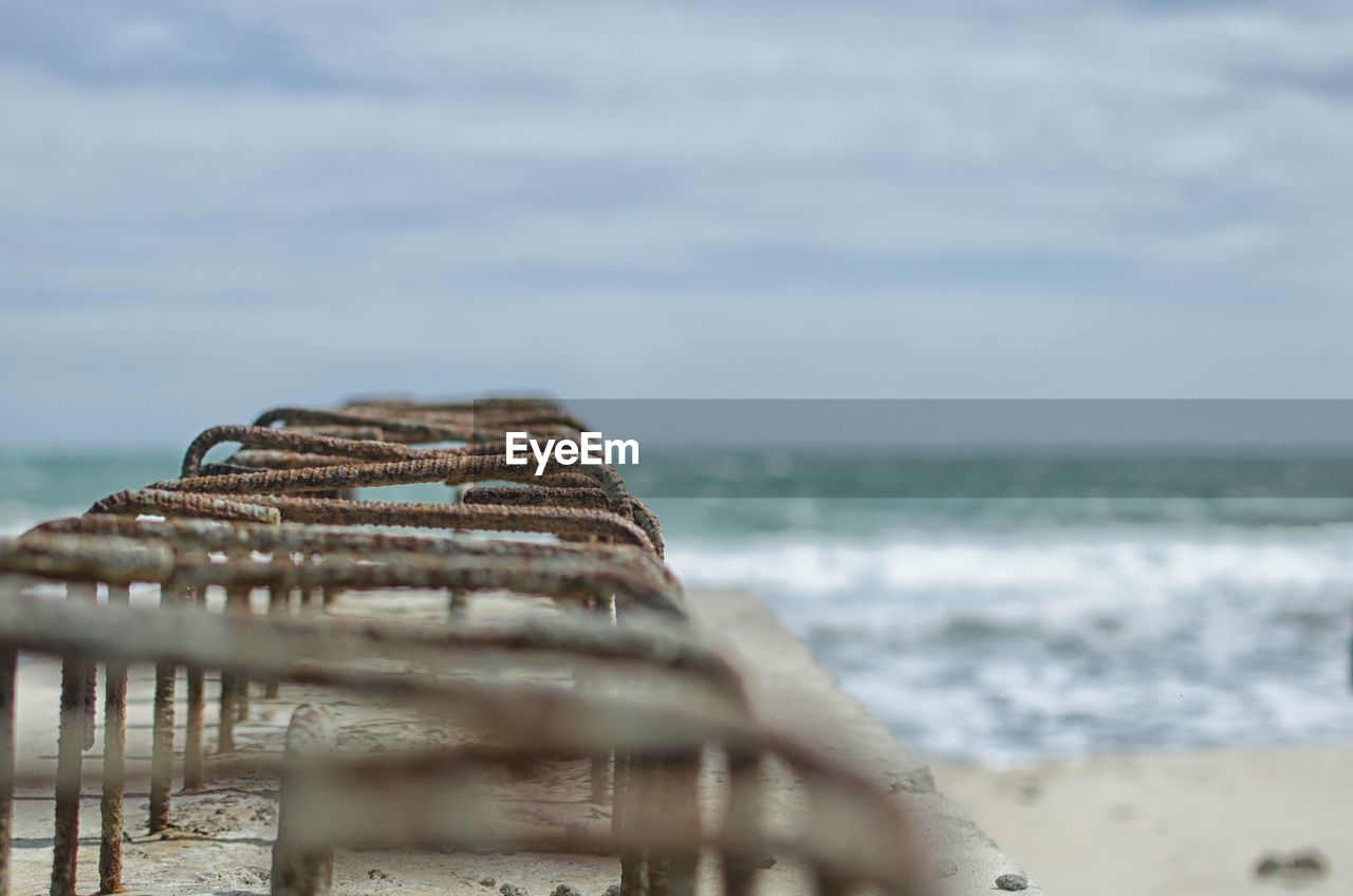 Scenic view of rusty iron bars on coast