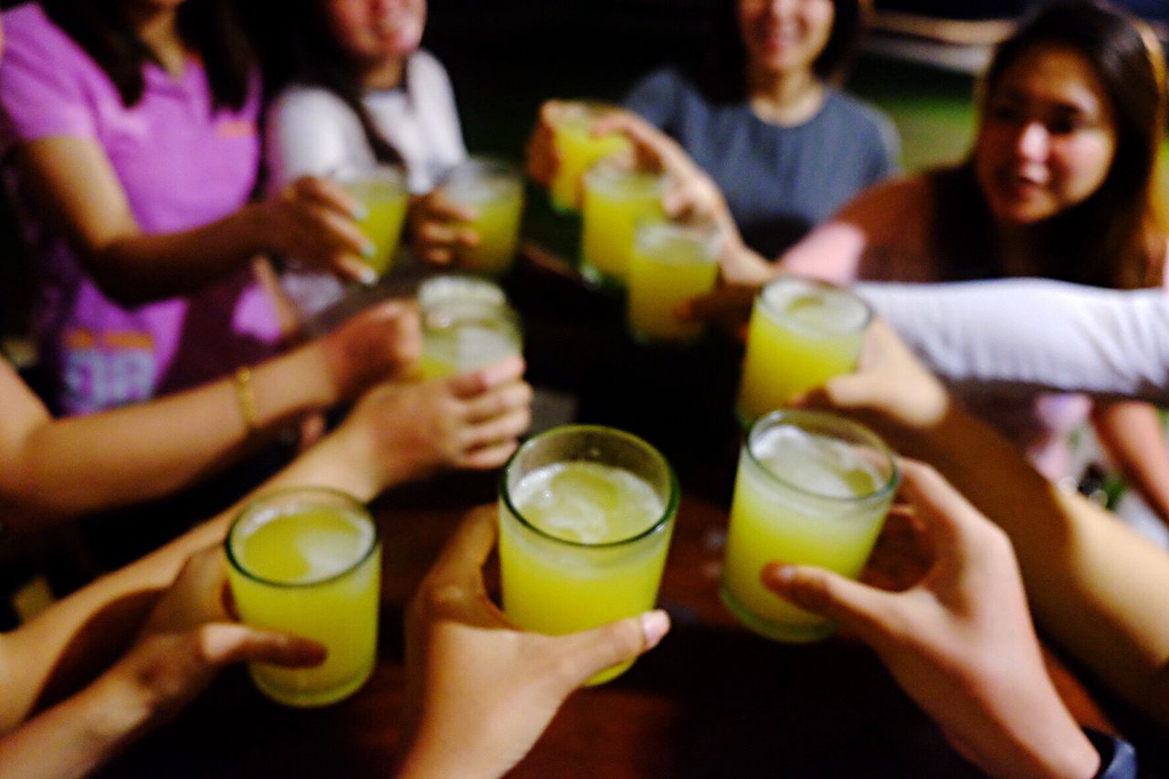 High angle view of friends toasting each other at party