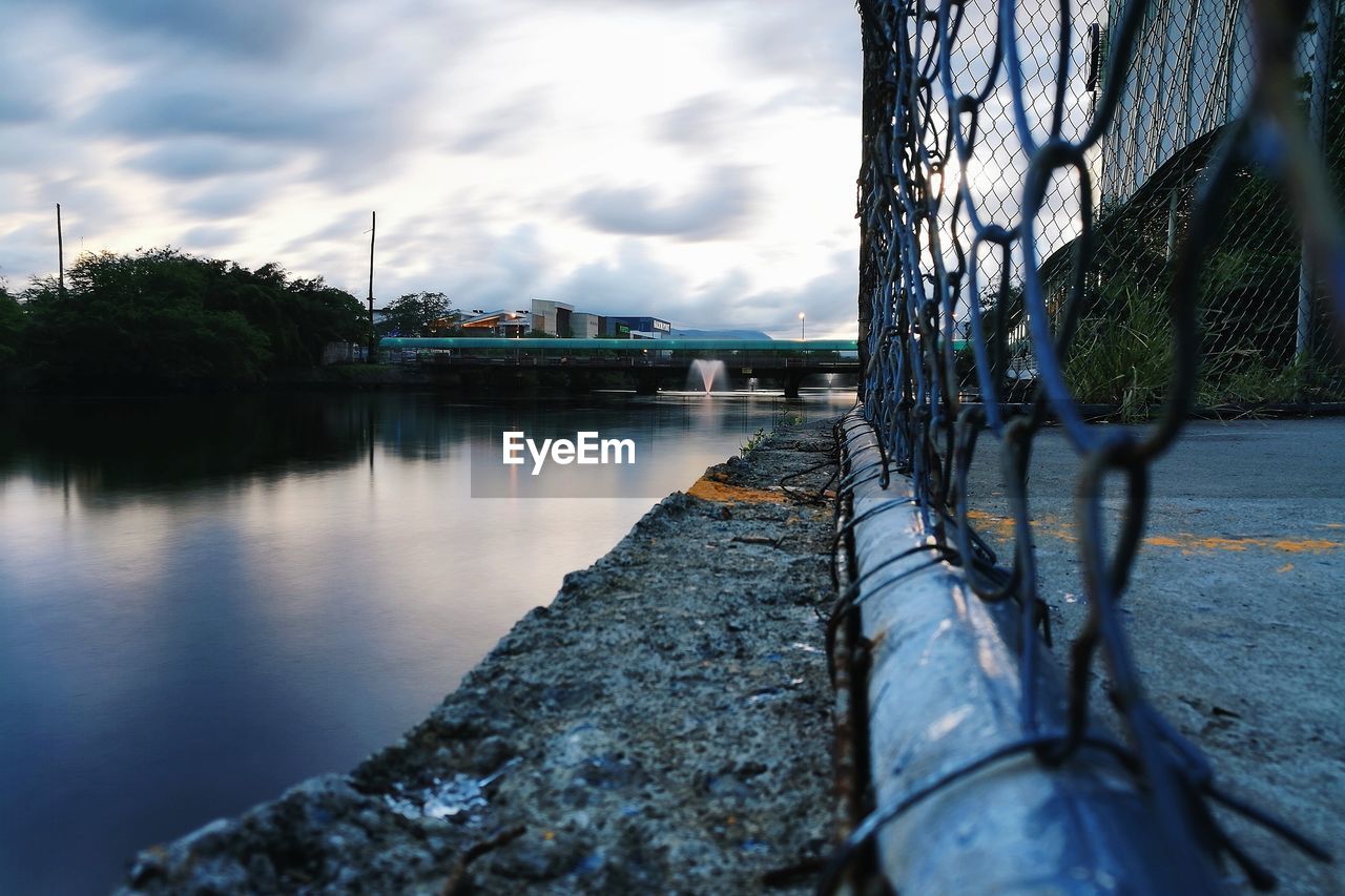 RIVER AMIDST CITY AGAINST SKY