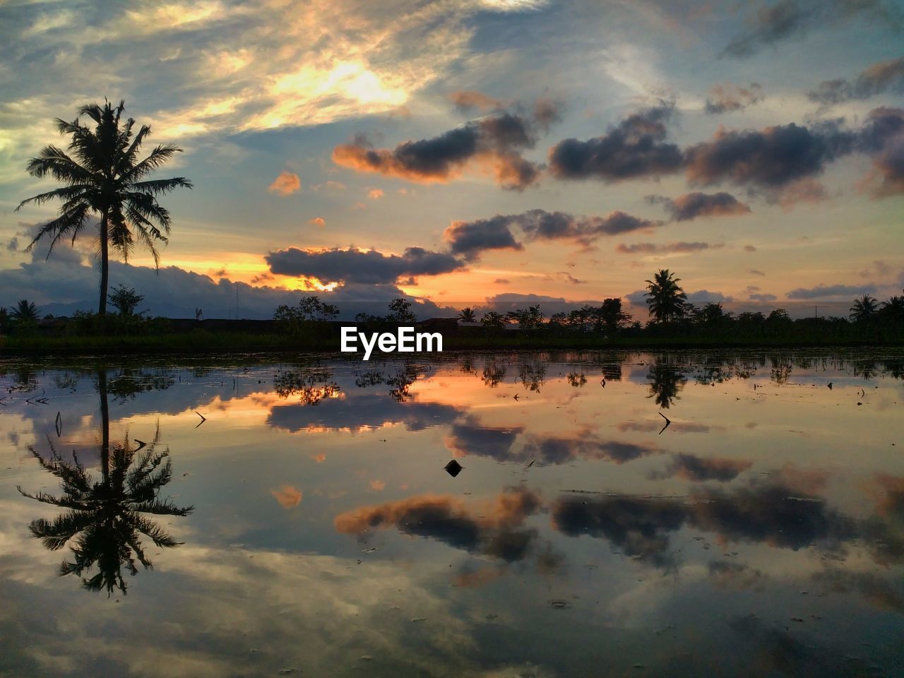 Scenic view of lake against sky during sunset