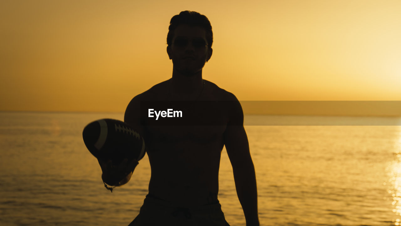 Silhouette of a football player with ball