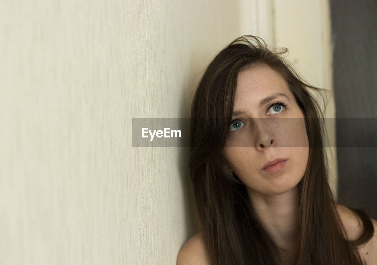 Portrait of a girl with long hair, with a sad look. a young girl is depressed, copy space. 