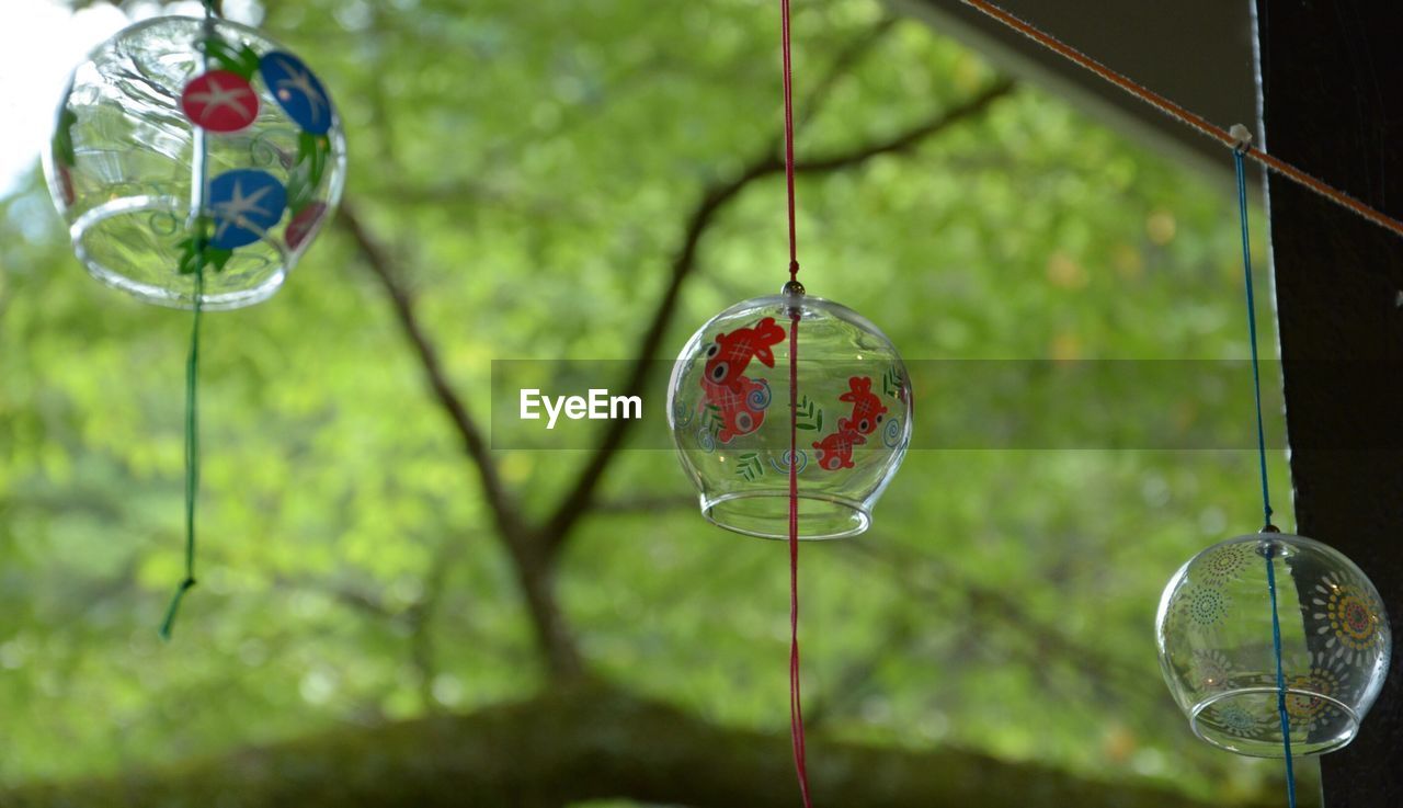 Low angle view of japanese wind bell hanging on rope