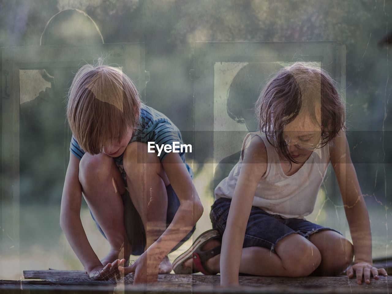 Double exposure of brother and sister playing and standing at window