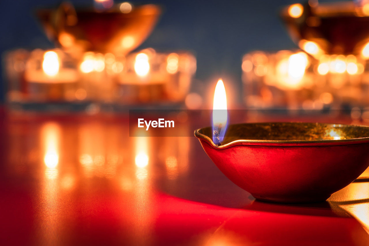 burning, flame, fire, illuminated, candle, religion, heat, tradition, lighting, no people, lighting equipment, spirituality, night, red, celebration, food and drink, reflection, belief, nature, focus on foreground, oil lamp, holiday, ceremony, close-up, selective focus, traditional festival, indoors, light, event, decoration