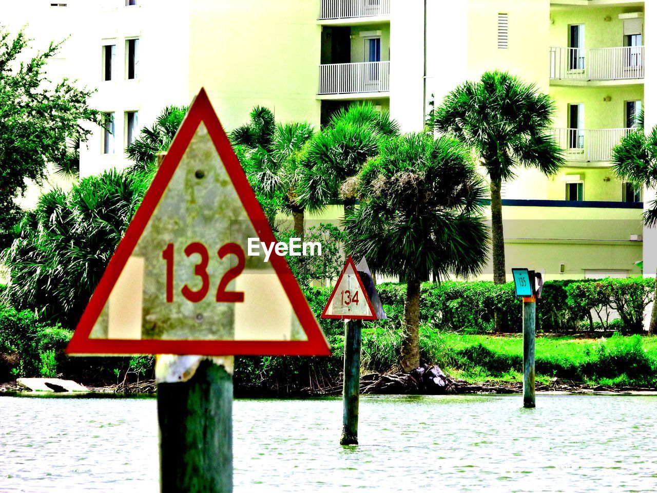 ROAD SIGN IN FRONT OF TREES