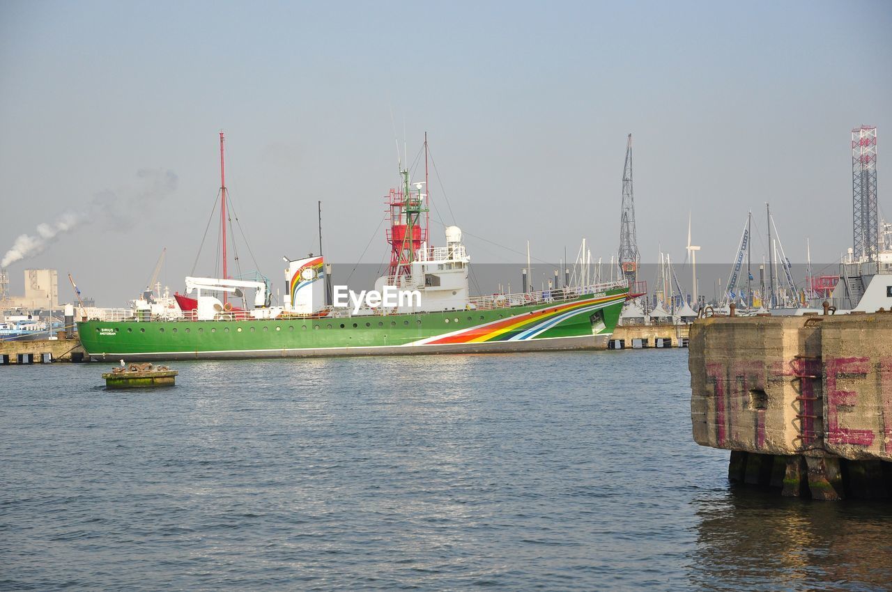 Commercial dock by sea against sky