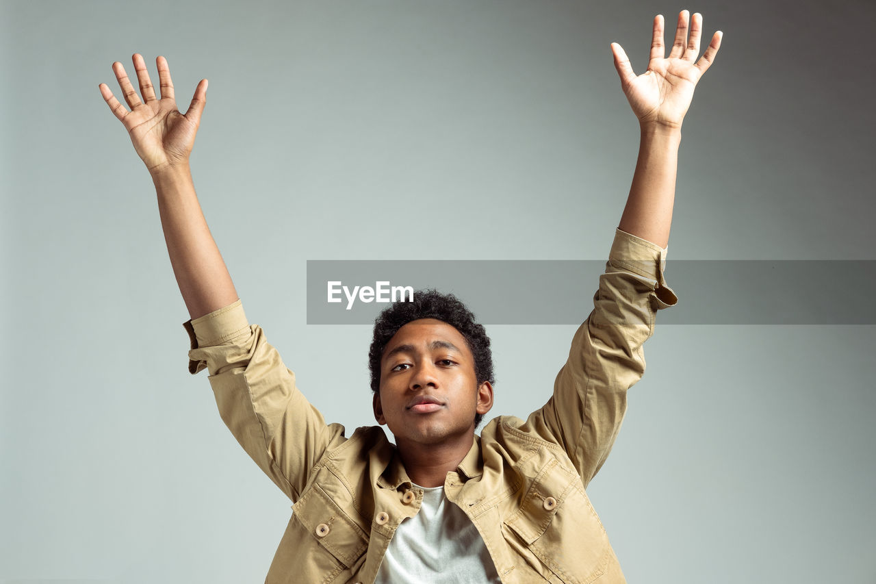 Portrait of young man against white background