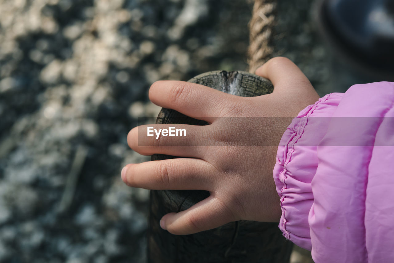 Cropped hand of child on railing