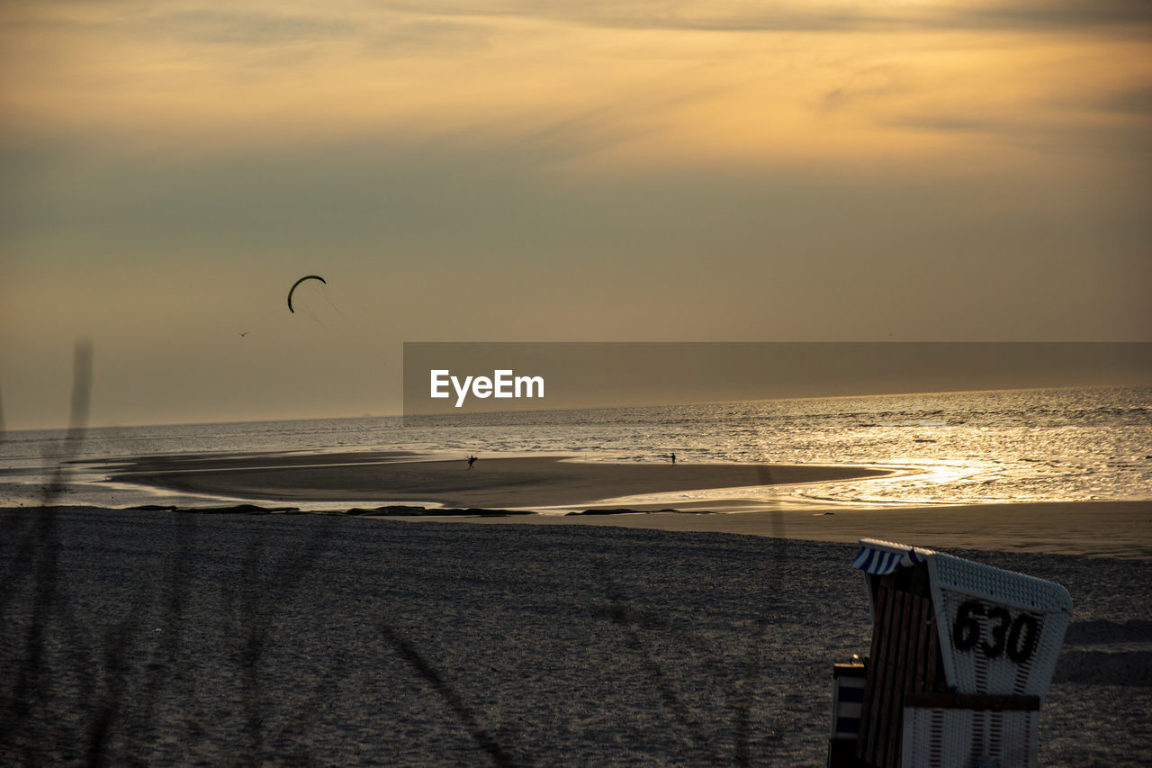 Scenic view of beach against sky during sunset