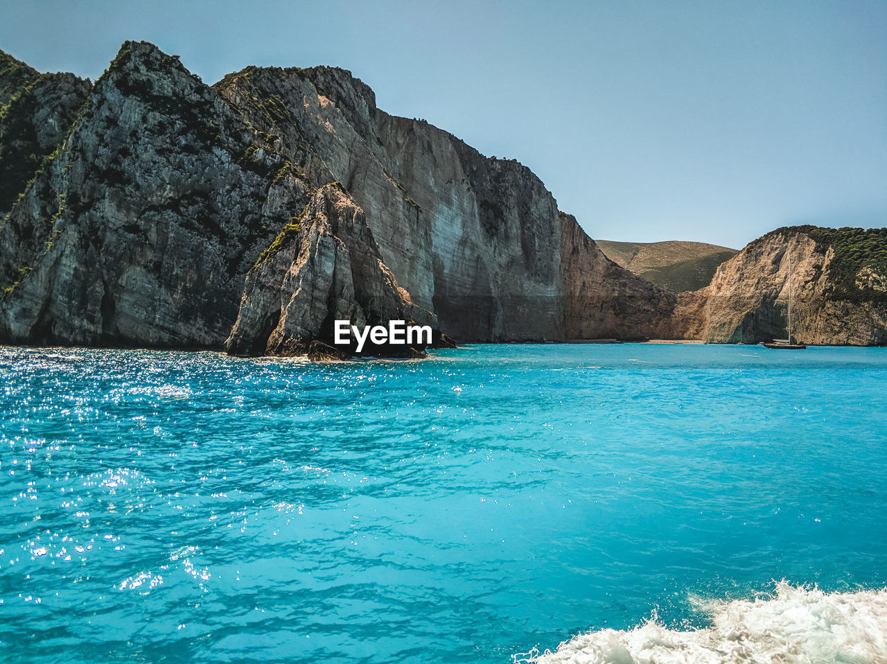 Scenic view of sea against clear blue sky