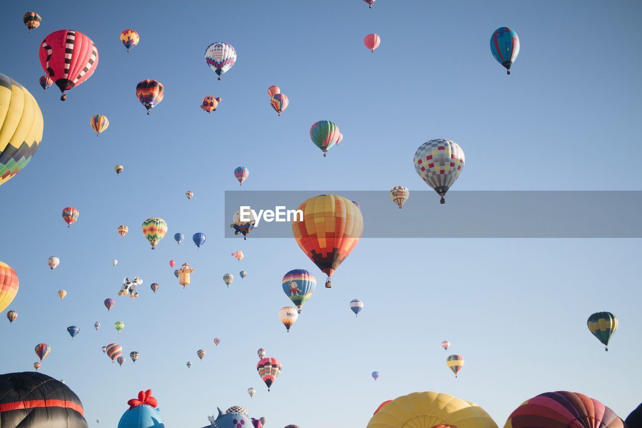 Low angle view of hot air balloons in clear sky