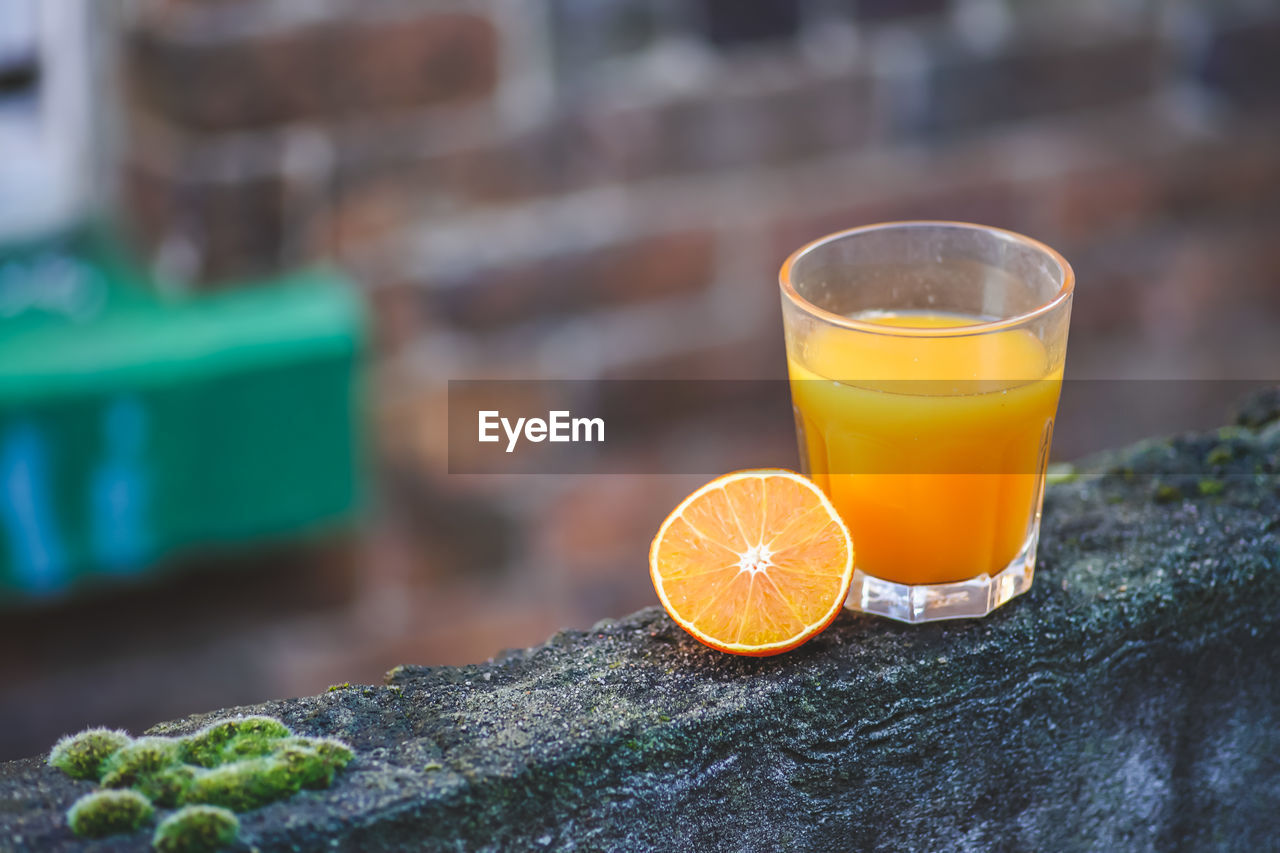 Glass of fresh orange juice on wooden table. healthy drink for the body immune system