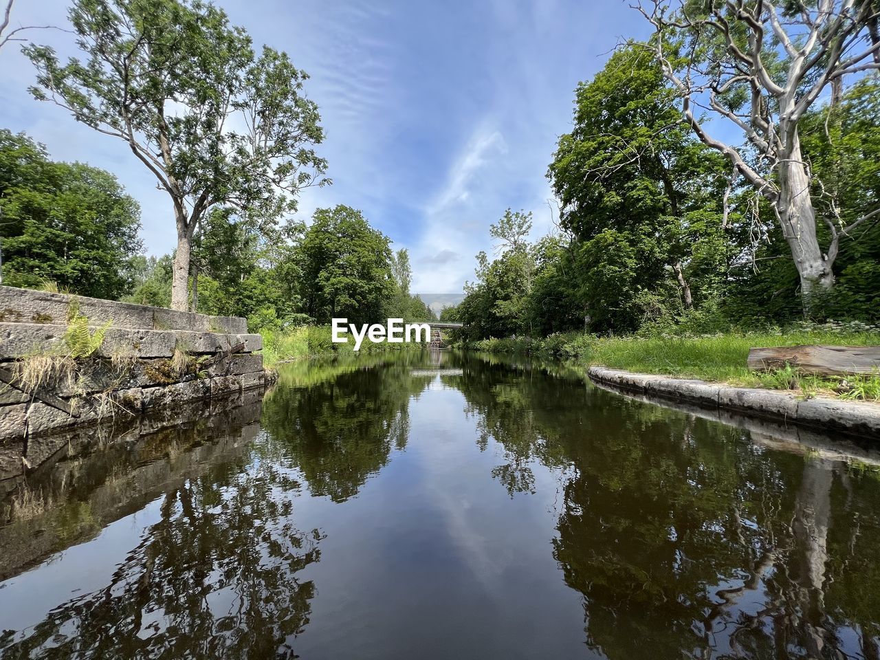 water, tree, reflection, plant, sky, lake, nature, beauty in nature, tranquility, body of water, cloud, scenics - nature, waterway, no people, environment, landscape, tranquil scene, outdoors, travel destinations, day, reflection lake, green, garden, stream, non-urban scene, travel, architecture, forest, tourism, blue, land, standing water, flower