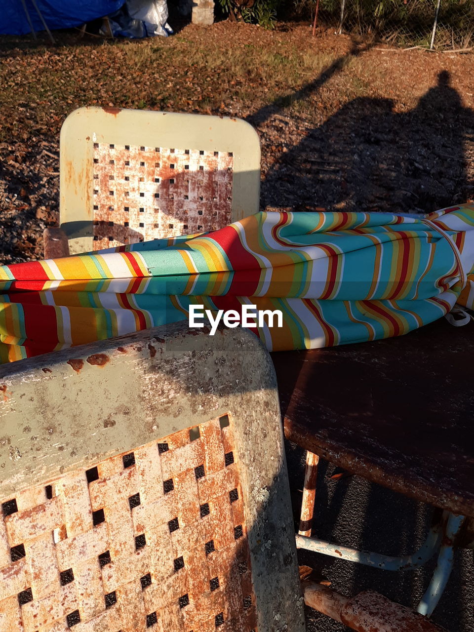 HIGH ANGLE VIEW OF MULTI COLORED CHAIRS AND TABLES ON TABLE