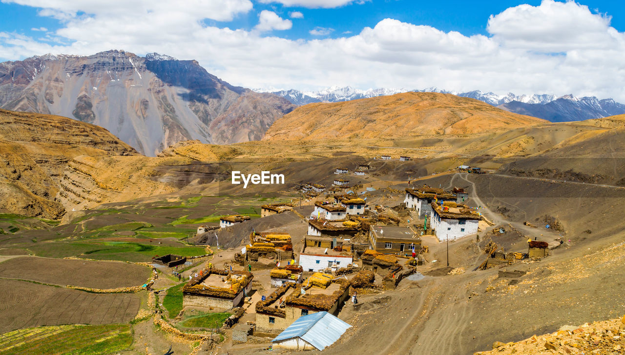 High angle view of buildings and mountains against sky
