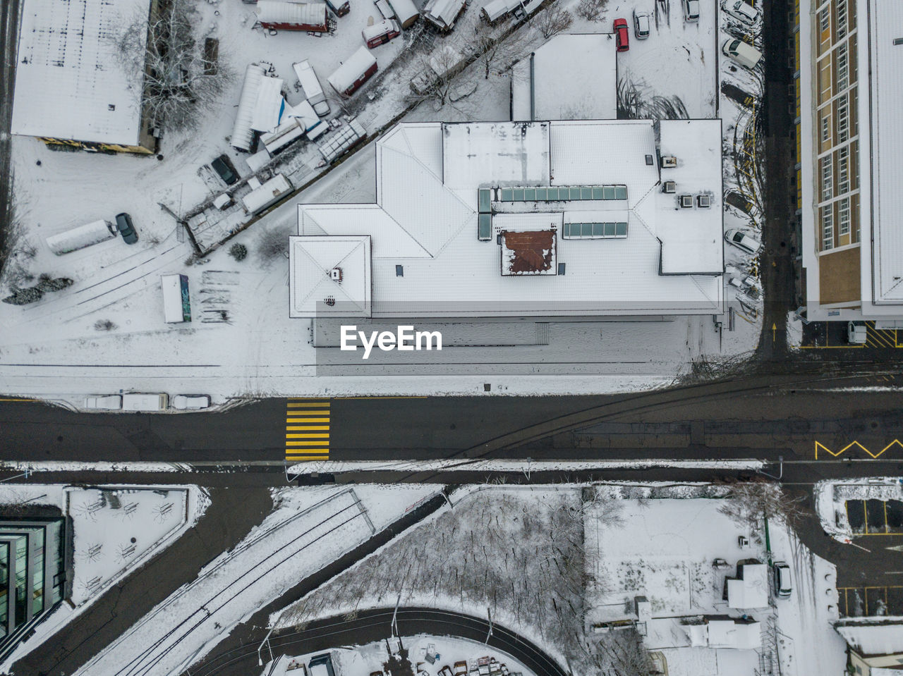 SNOW COVERED RAILROAD TRACKS AMIDST BUILDINGS