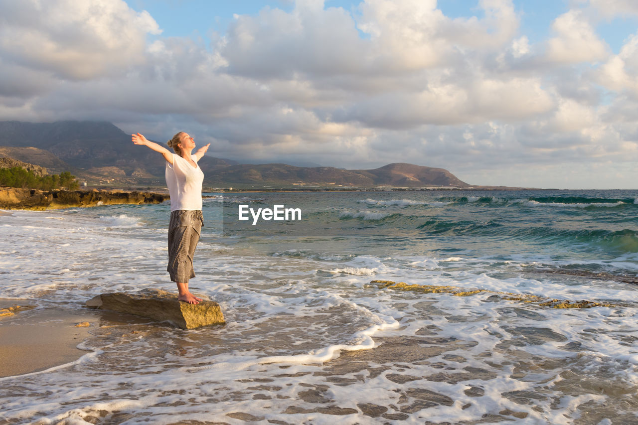 MAN STANDING ON BEACH