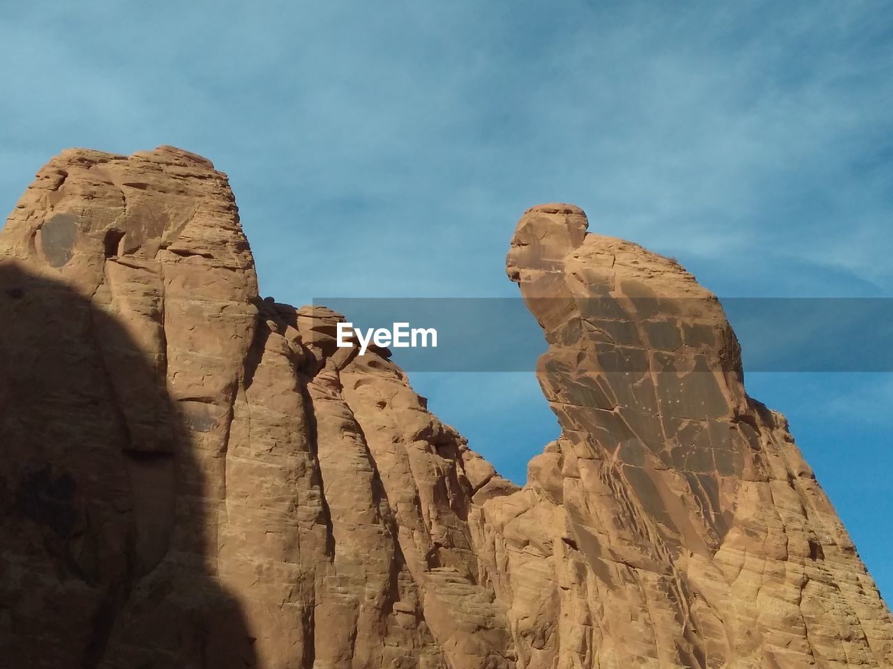 STATUE OF ROCK FORMATION AGAINST SKY