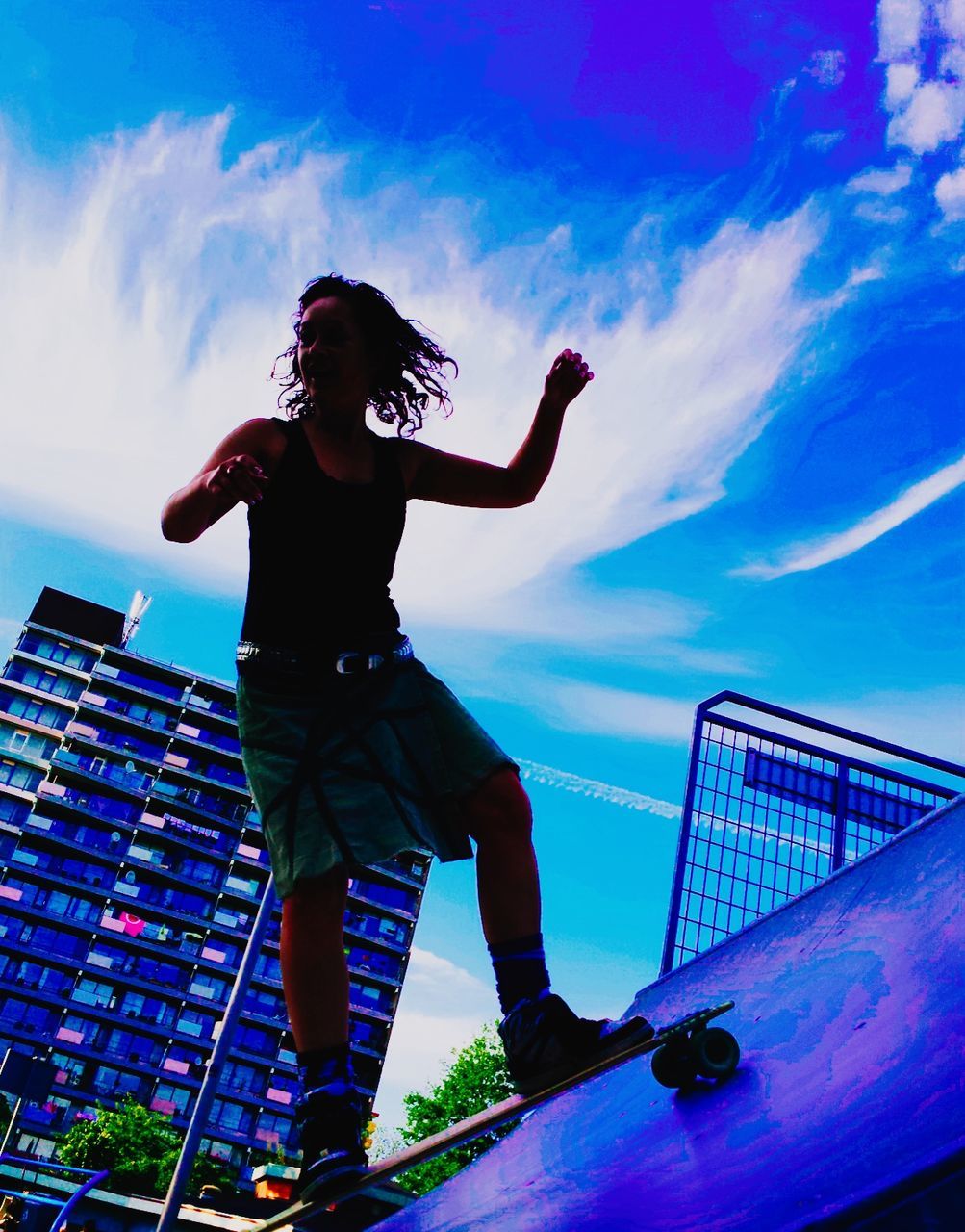 LOW ANGLE VIEW OF JUMPING JUMPING AGAINST CLEAR BLUE SKY