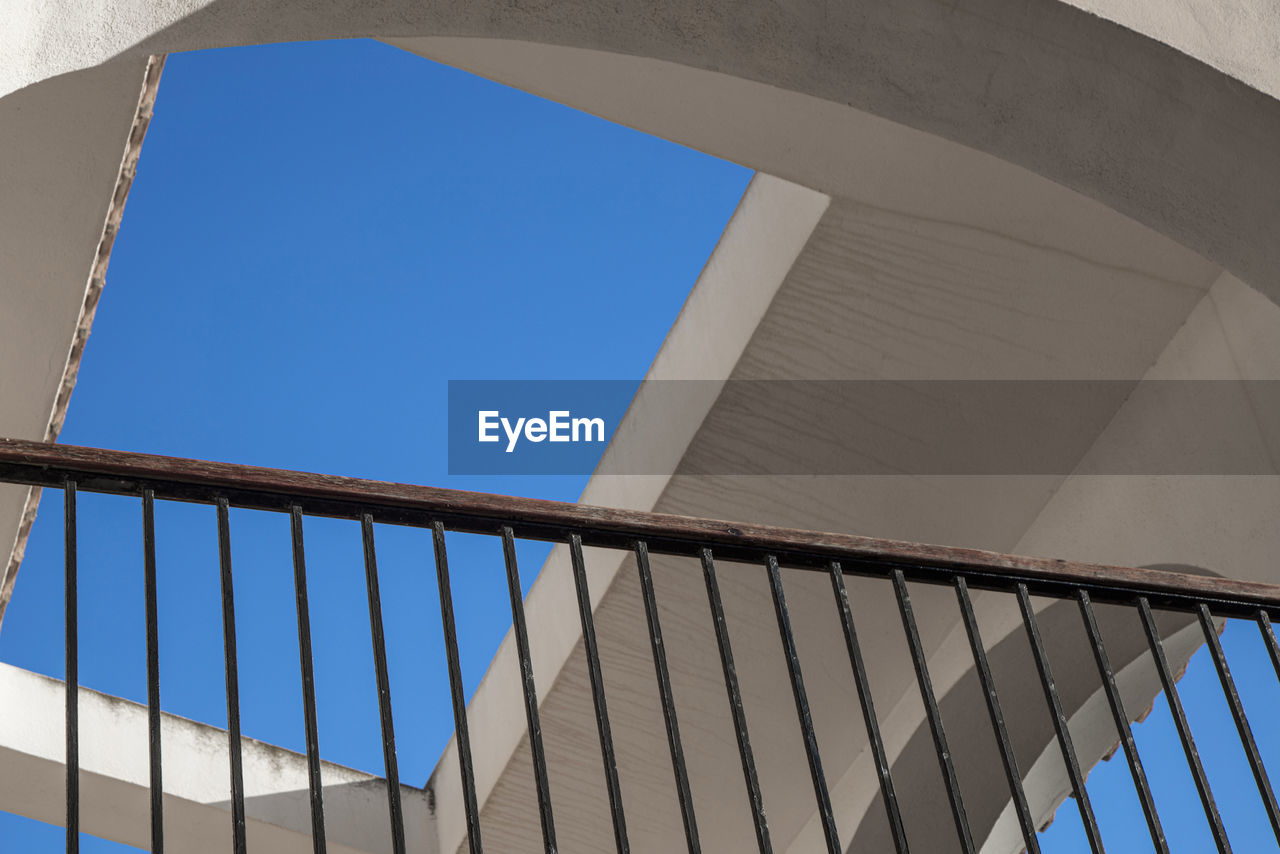 LOW ANGLE VIEW OF BUILDING AGAINST SKY SEEN THROUGH WINDOW