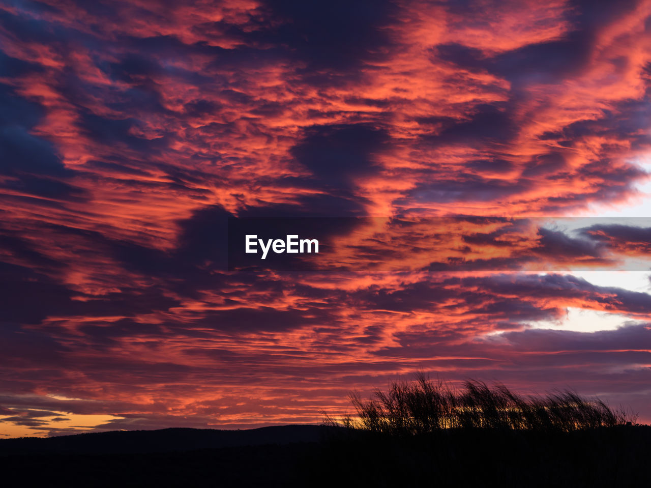 Low angle view of dramatic sky during sunset