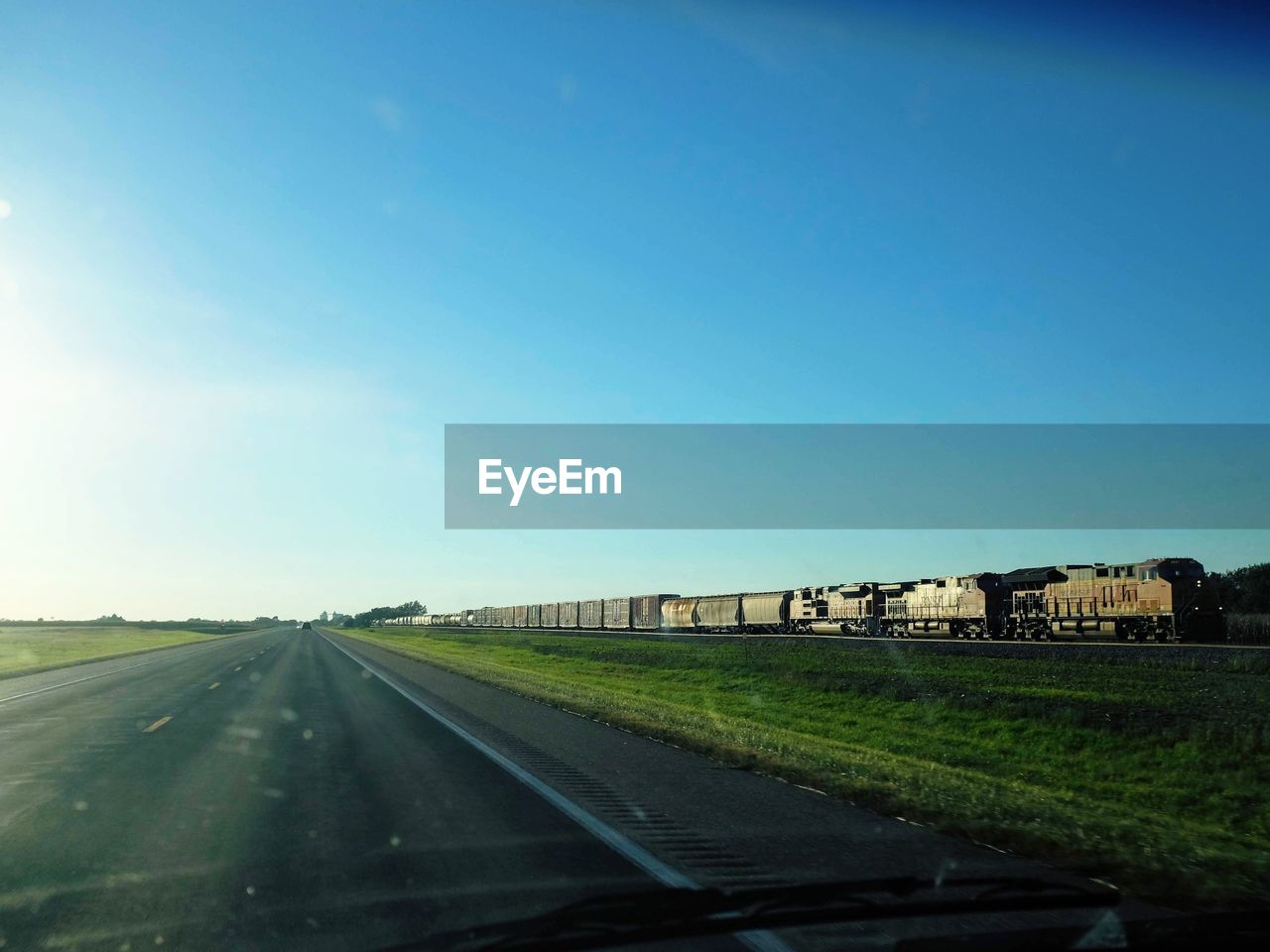 ROAD BY LAND AGAINST CLEAR BLUE SKY